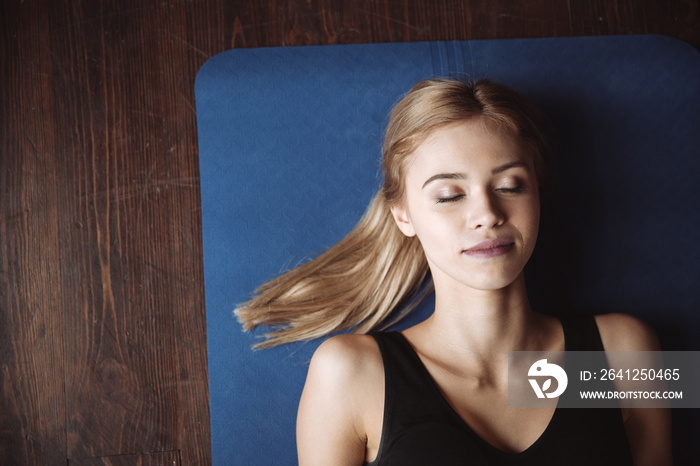 Top view of fitness woman lying with eyes closed