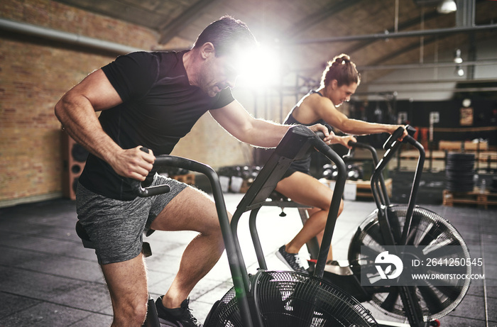 Man and woman riding fast on simulators