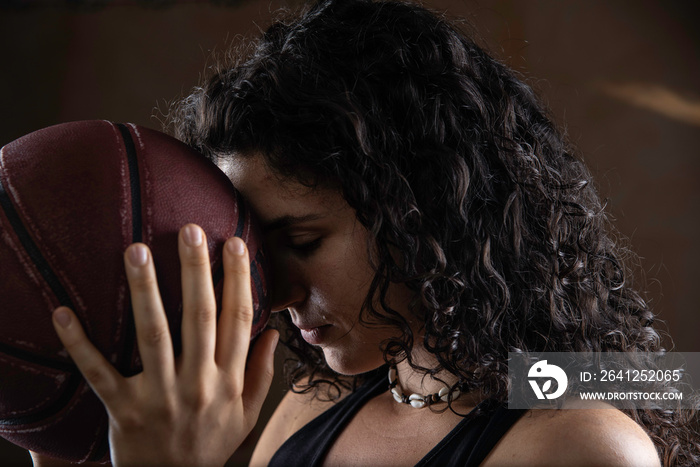 Young sportswoman holding basketball ball