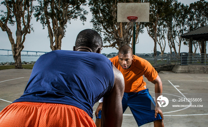 Young basketball players playing on court, close up