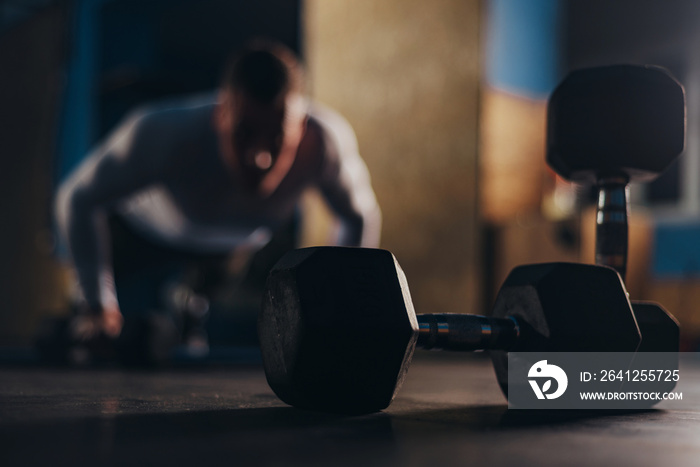 Man training with dumbbells in the gym