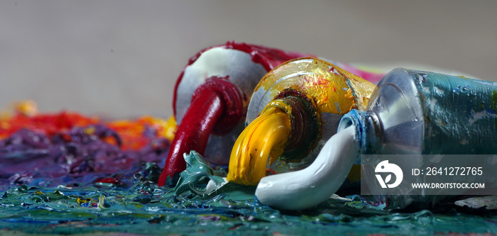 tubes with art oil paint on a palette. colorful art paints close-up. selective focus