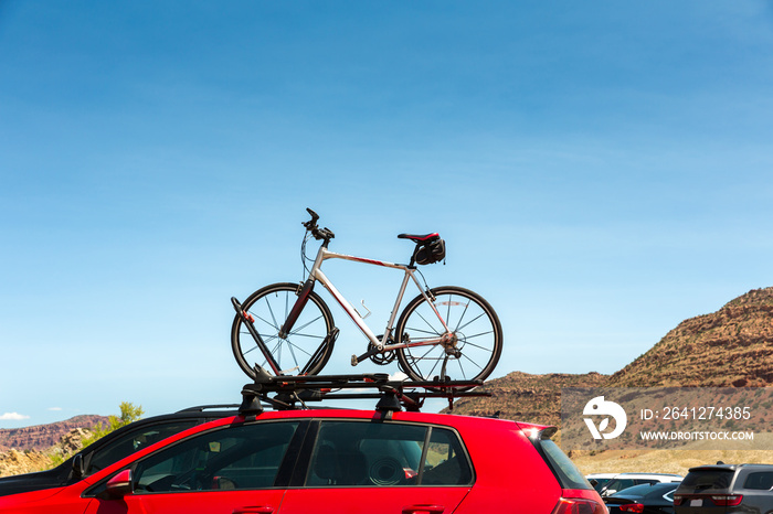 Car is transporting bicycle on the roof.