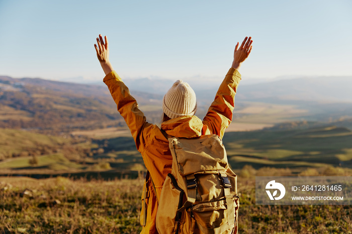 woman traveler in a yellow jacket in a hat backpack travel mountains Lifestyle