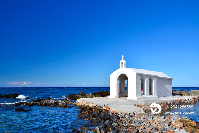 Small white church in sea near Georgioupolis town on Crete, Greece