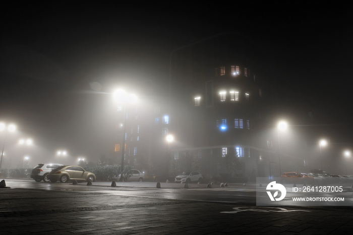 Residential building at night in the fog