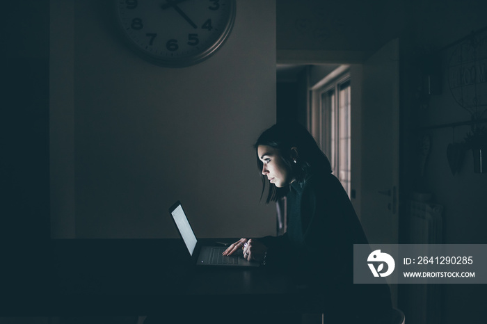 Young beautiful caucasian woman working late form home using computer - studying, overtime, responsi