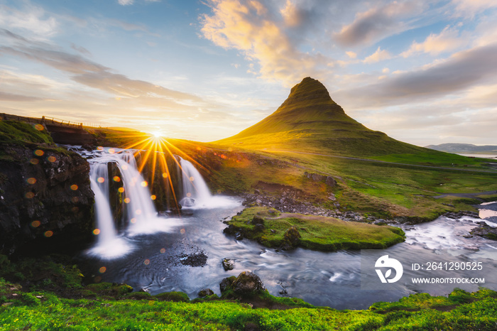 Morning landscape with rising sun on Kirkjufellsfoss waterfall and Kirkjufell mountain, Iceland, Eur