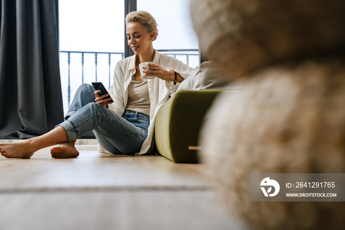 Woman relaxing while leaning on a sofa