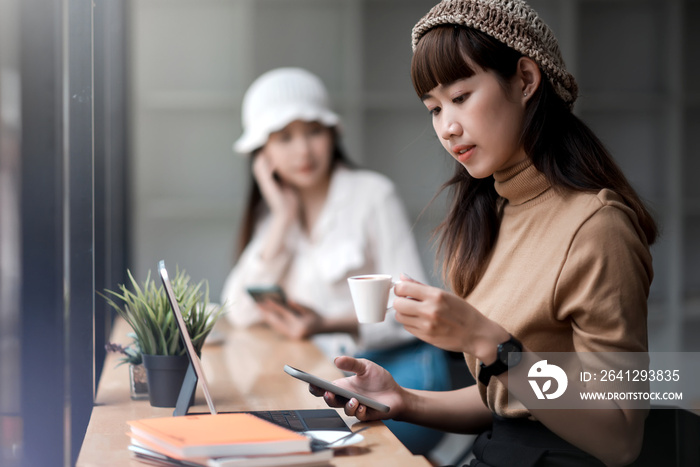 Asian beautiful woman drinking coffee winter morning sitting by the window.