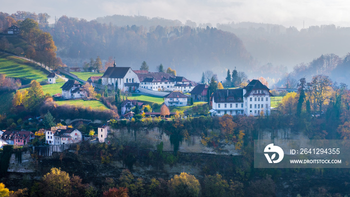 A beautiful and colorful foggy autumn landscape around the historic city of Fribourg, Switzerland