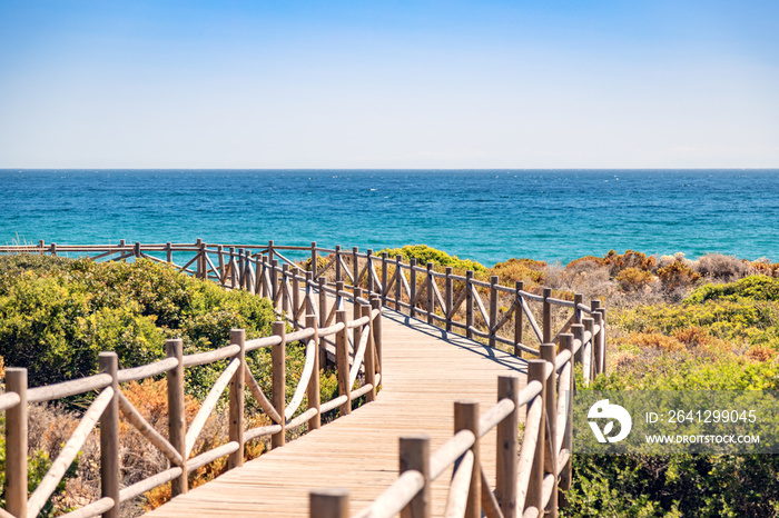 Cabopino beach, Marbella, Malaga. Wooden walkway to the beach.