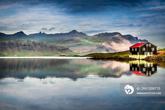 Small house on river bank in Iceland