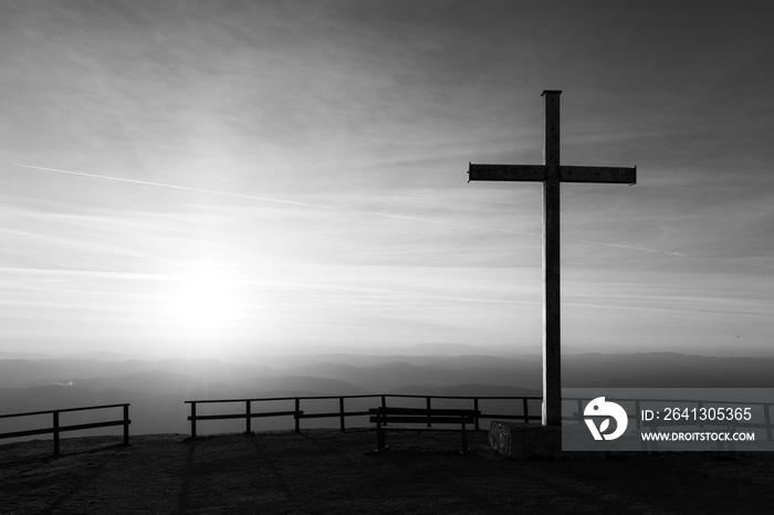 Cross on top of Mt. Serrasanta (Umbria, Italy), with sun low on the horizon