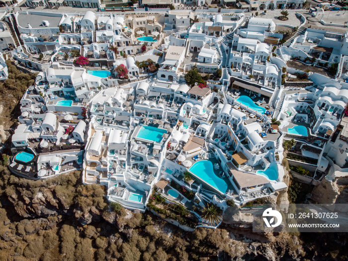 Drone view over Santorini, aerial view over the whitewashed village of Oia with luxury vacation reso