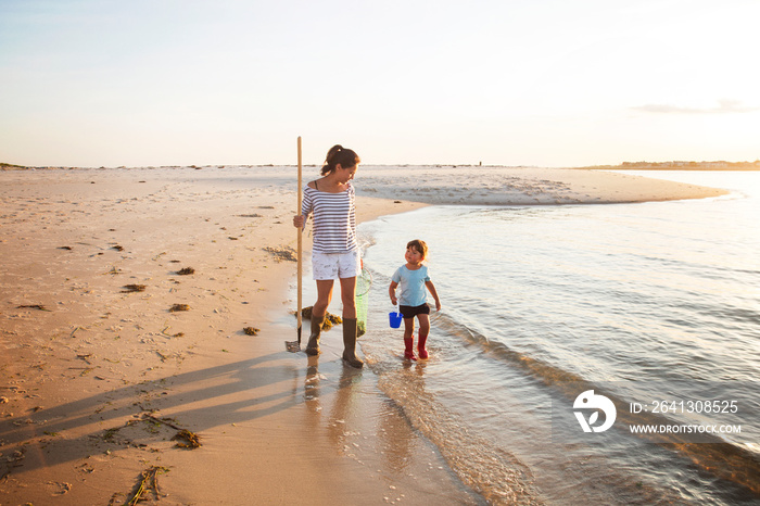 Mother and daughter (2-3) on beach