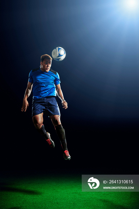 Male soccer player heading ball