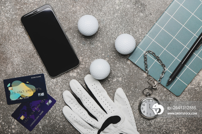 垃圾背景下的信用卡、手机和高尔夫手套。体育博彩的概念