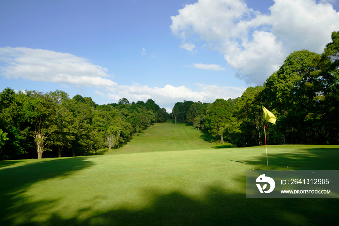 The evening golf course has sunlight shining down at golf course in Thailand