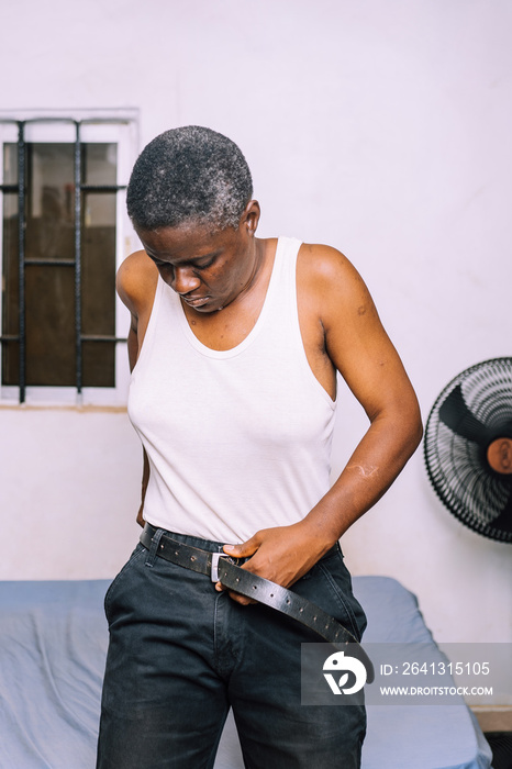 A queer masculine woman dressing up