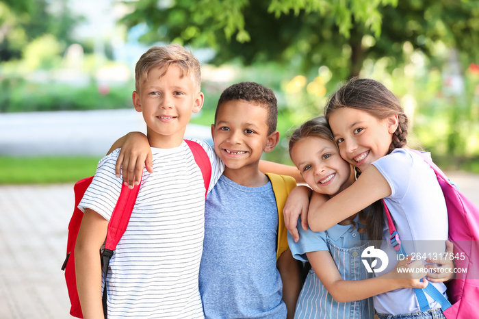 Group of cute little pupils outdoors