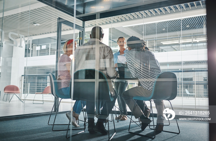 Young businesswoman meeting with her team in a boardroom