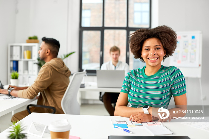 business and people concept - happy smiling african american woman with smart watch at office