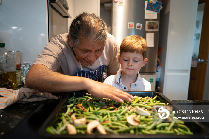 Senior man with grandson cooking together