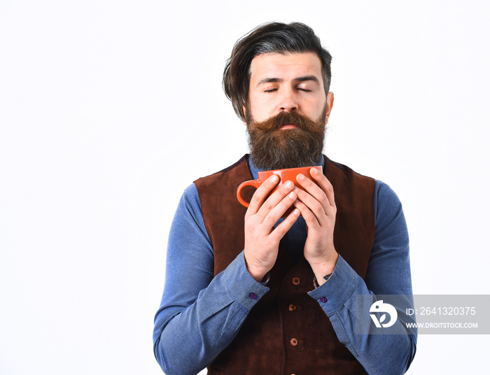 bearded man holding cup with coffee, tea with serious face