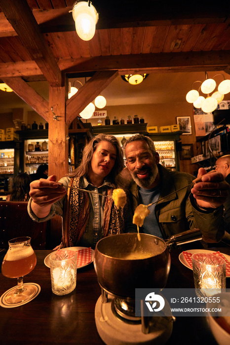 Mature couple having food in restaurant