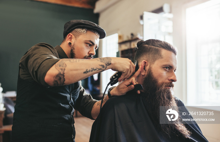 Man getting trendy haircut in barbershop