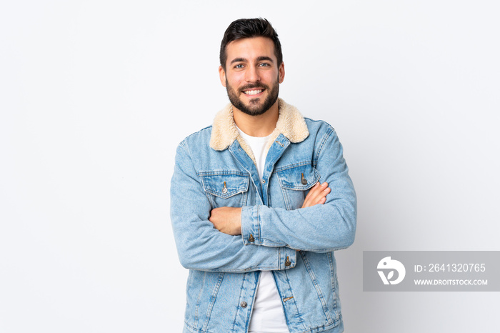 Young handsome man with beard isolated on white background keeping the arms crossed in frontal posit