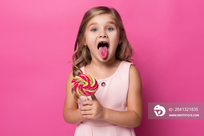 girl shows tongue stained with sweets