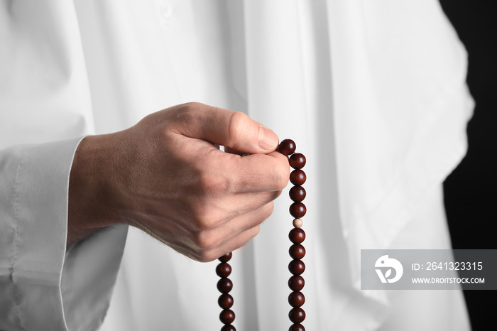 Muslim man with prayer beads, closeup