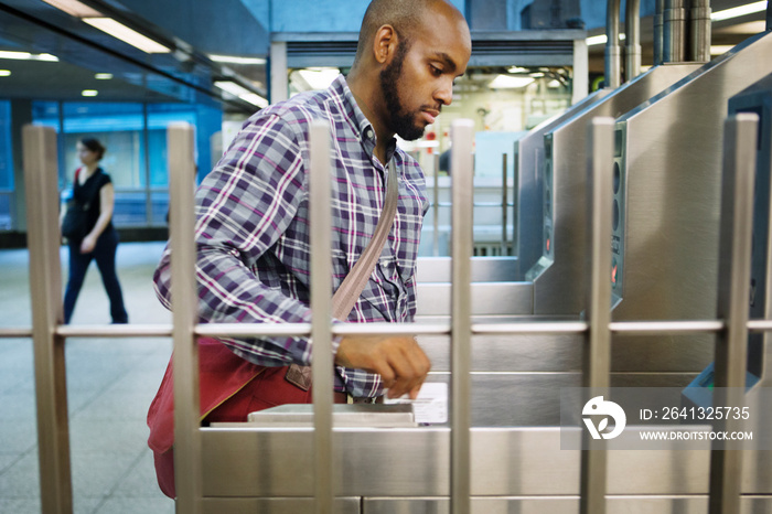 Young man entering subway station