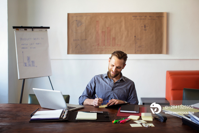 Smiling young man working in office