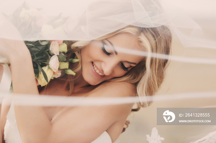 portrait of a beautiful blonde bride with a bouquet of flowers ith wedding makeup and hairstyle. lux