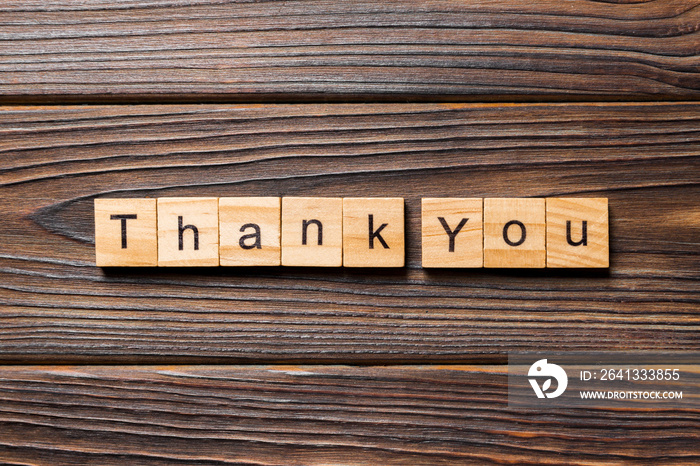 thank you word written on wood block. thank you text on table, concept