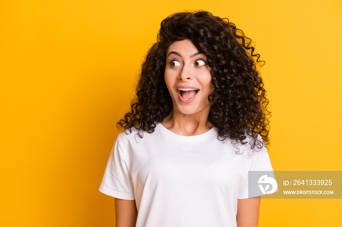 Photo portrait of amazed girl looking empty space staring opened mouth isolated on vivid yellow colo