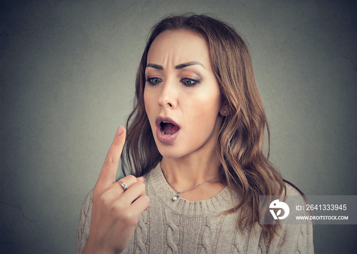 Shocked woman looking at her finger has double vision