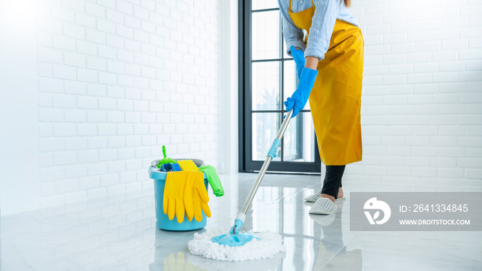 Young housekeeper or washing cleaning floor at mop in protective gloves, Housework Cleaning service.