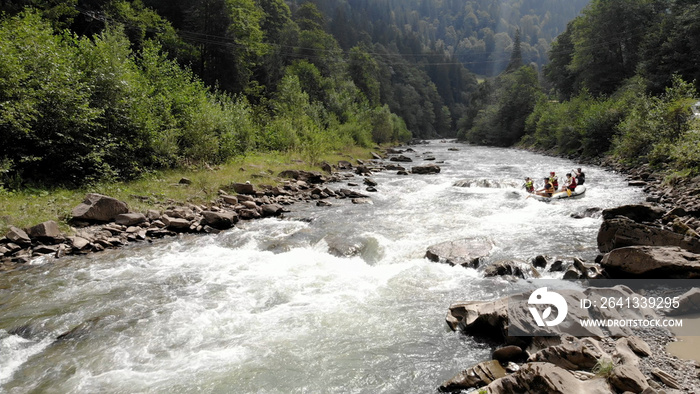 Team of athletes on an inflatable boat. Rafting on white water.