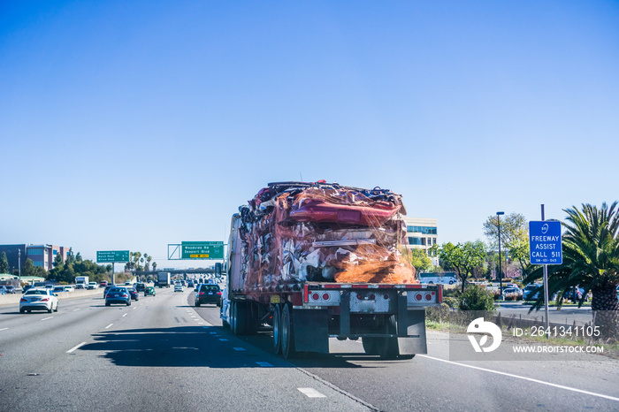 Truck carrying crushed car bodies for recycling, San Francisco bay area, California