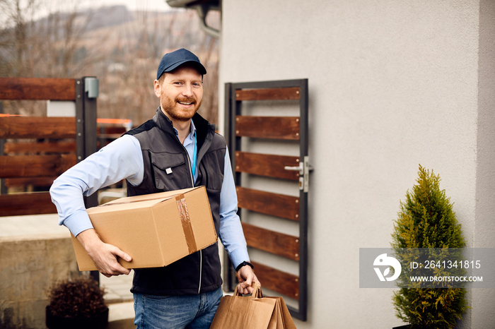 Portrait of happy delivery man at work looking at camera.