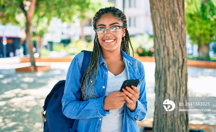 Young african american student woman smiling happy using smartphone at the university campus