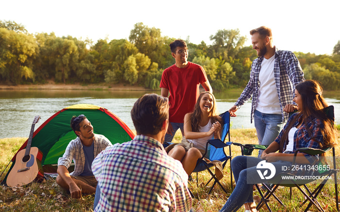 A group of friends have a picnic in a forest in autumn.