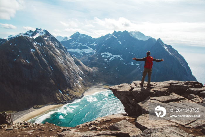 Man stand on cliff edge alone enjoying aerial view backpacking lifestyle travel adventure outdoor va