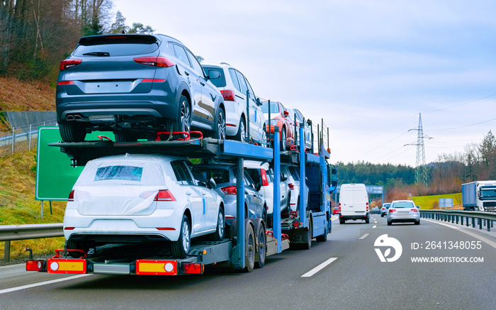 Car carrier transporter truck on road reflex