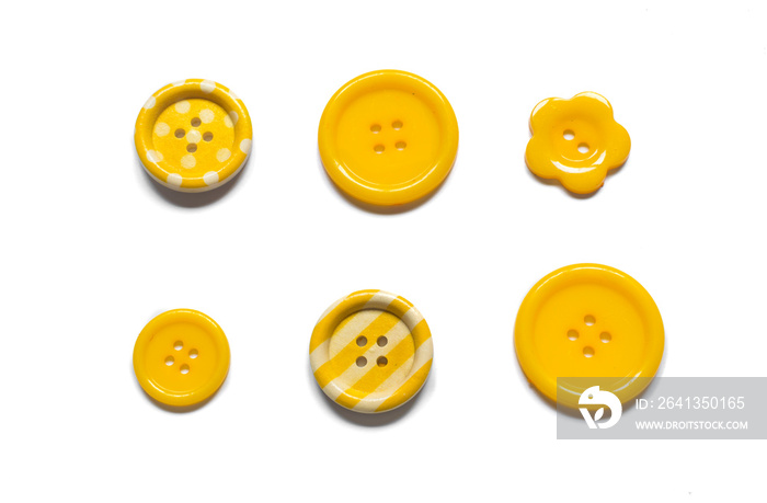 Various yellow sewing buttons isolated on white background