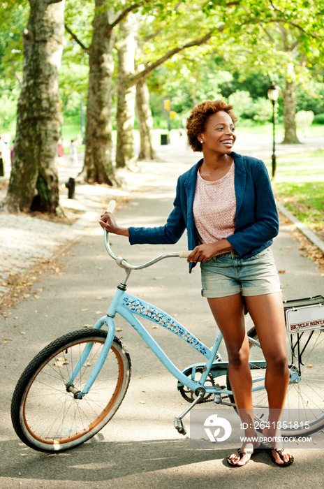 Woman with bike in park